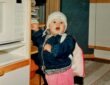 toddler standing next to microwave oven