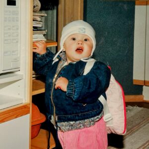 toddler standing next to microwave oven